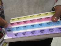 Pharmacist showing pill dispenser